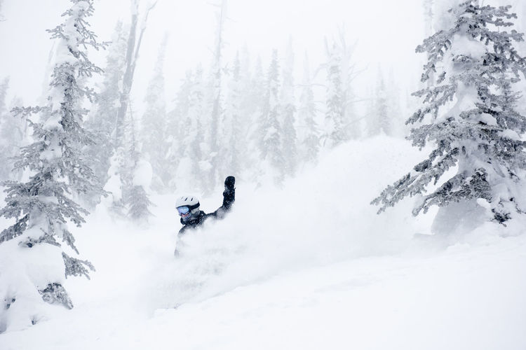 Asnowboarder finds pure happiness taking a turn in deep powder