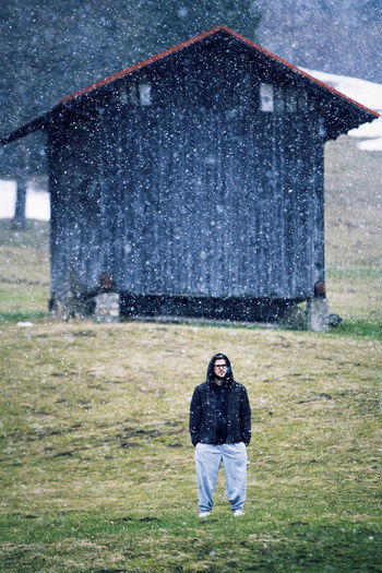 Rear view of woman standing on grassy field