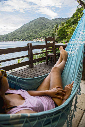 Woman relaxing in hammock on the tropical island og ilha grande