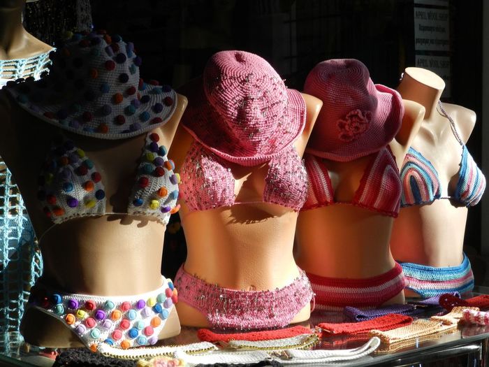 Bikinis and hats on mannequins displayed at shop