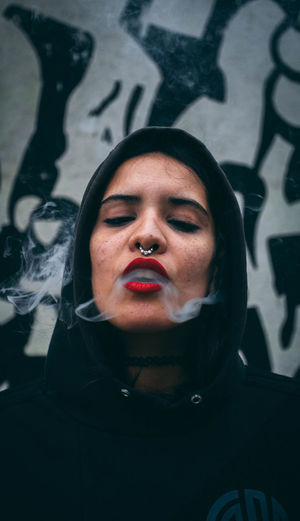 Close-up of woman exhaling smoke