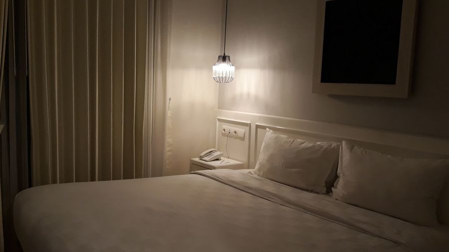 Illuminated electric lamp in bedroom at home