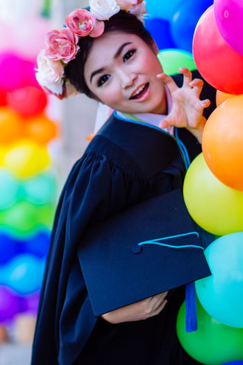Portrait of smiling young woman with balloons