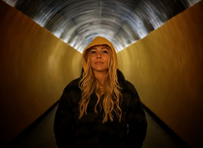 Portrait of woman standing in tunnel 