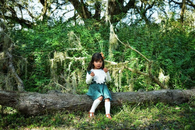 Full length portrait of girl in forest