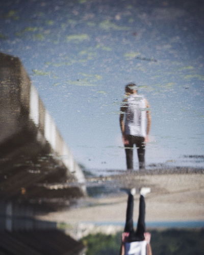 Rear view of man walking on water