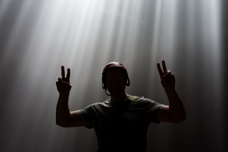 Man wearing helmet showing peace sign