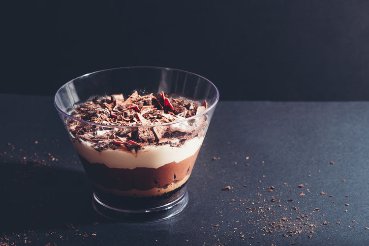  pot of irresistible layered billionaires dessert made from chocolate and caramel mousse layers