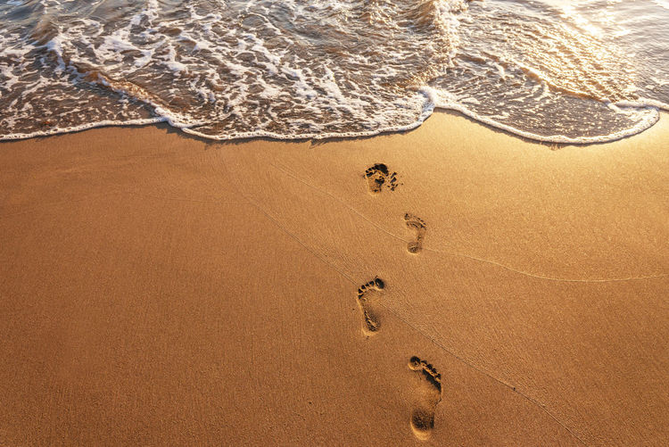 Footsteps on the beach at summer.