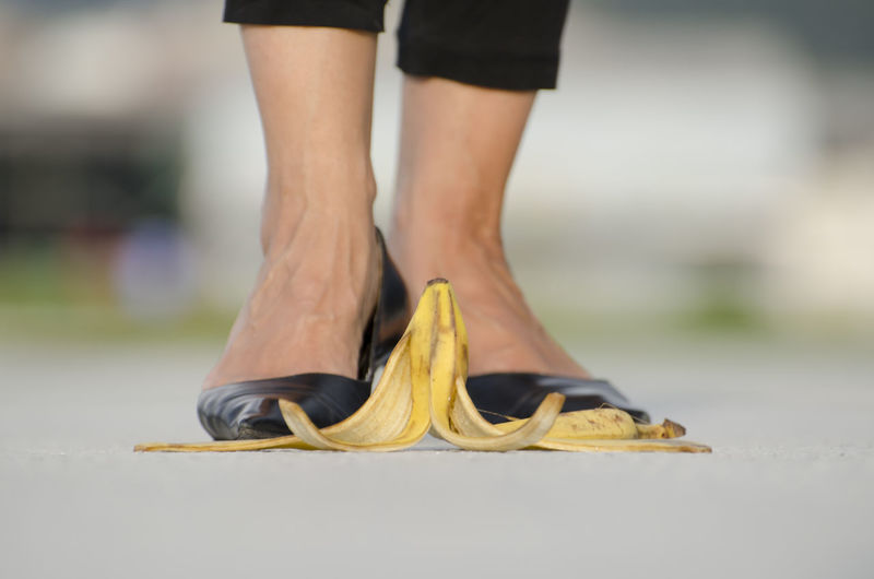 Woman with high heels standing in front of banana peel