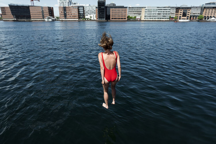 Rear view of woman diving in river