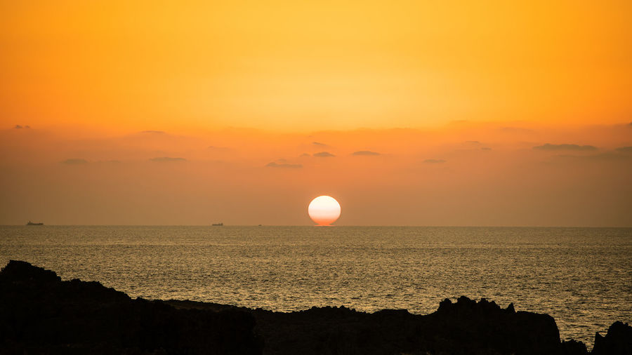 Scenic view of sea against sky during sunset