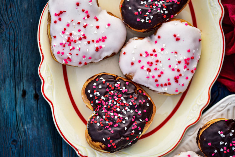 Valentines day chocolate and vanilla heart donuts with colorful tiny heart sprinkles