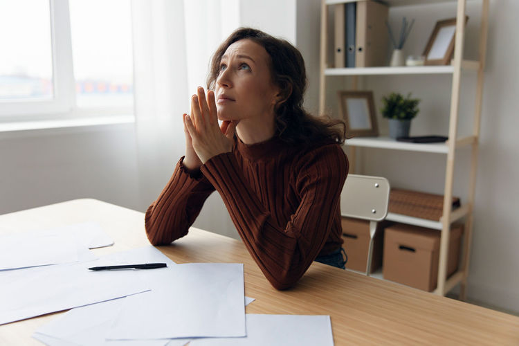 Frustrated businesswoman sitting at office