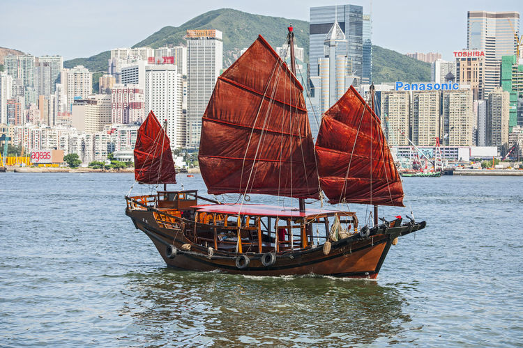 Traditional junk boat at victoria harbour in hong kong
