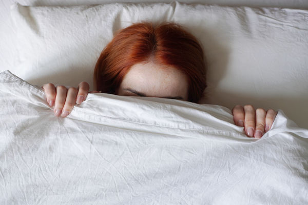High angle view of woman lying on bed at home