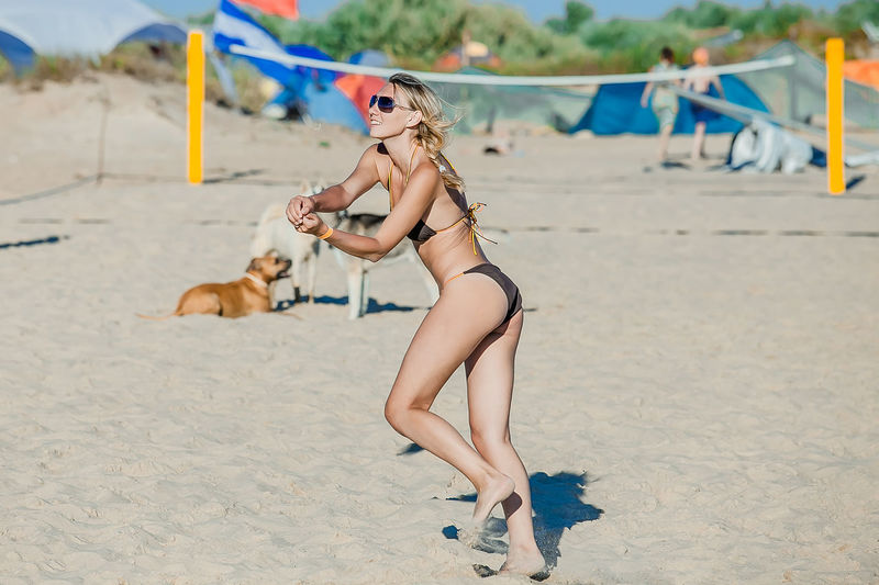 Full length of woman playing bikini on beach