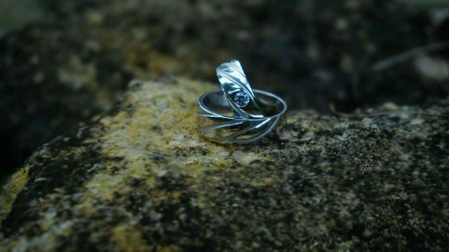 Close-up of wedding rings on rock