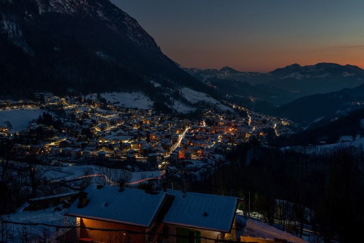 Mountain village icon snow at sunset