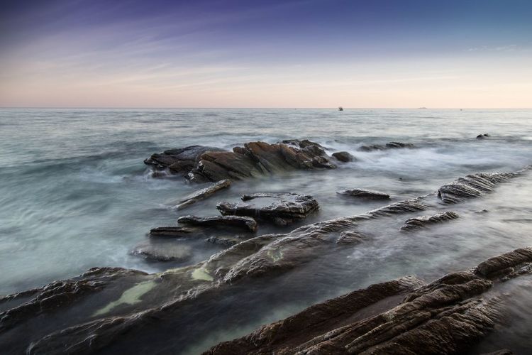Scenic view of sea against clear sky during sunset