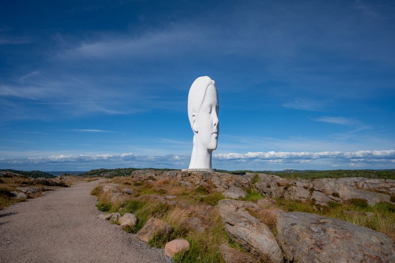 Rock formations on landscape against blue sky