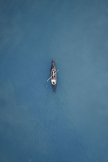 High angle view of person sailing on sea in canoe
