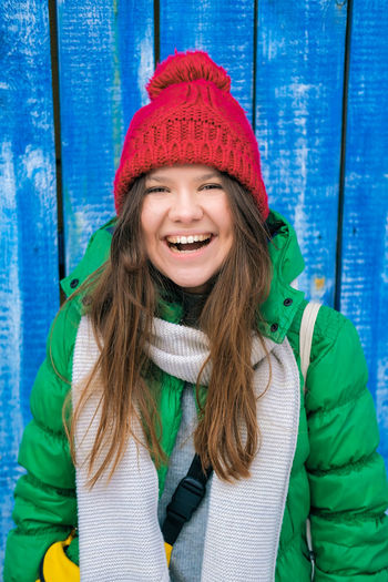 Portrait of smiling young woman wearing hat during winter