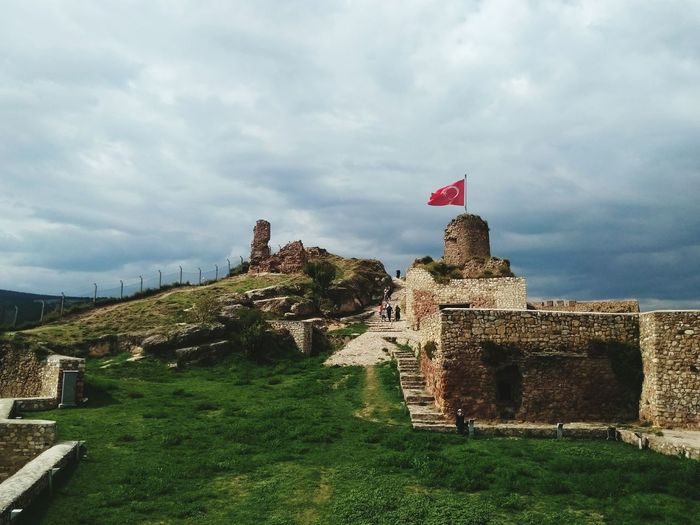 Turkish flag on kastamonu kalesi against cloudy sky