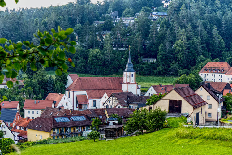 Scenic view of a village  with a church in upper franconia
