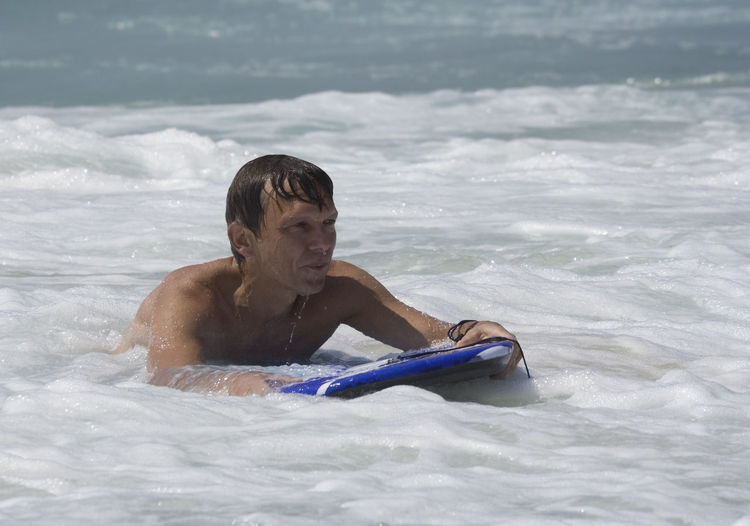 Man surfboarding in sea