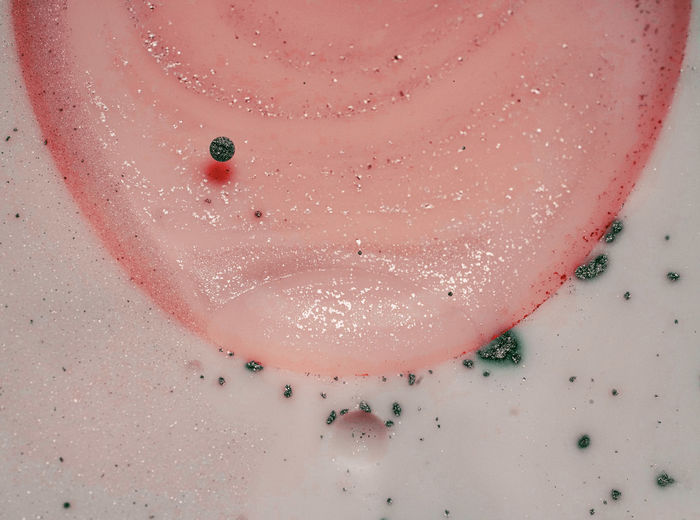 High angle view of pink bubbles in container