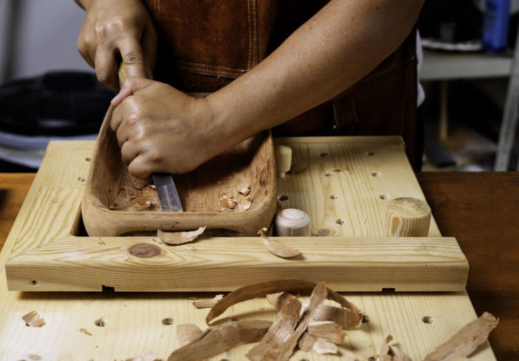 Craftswoman working with wooden tray