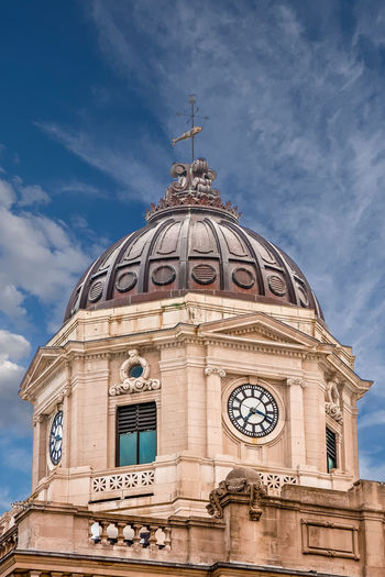 Low angle view of clock tower against sky