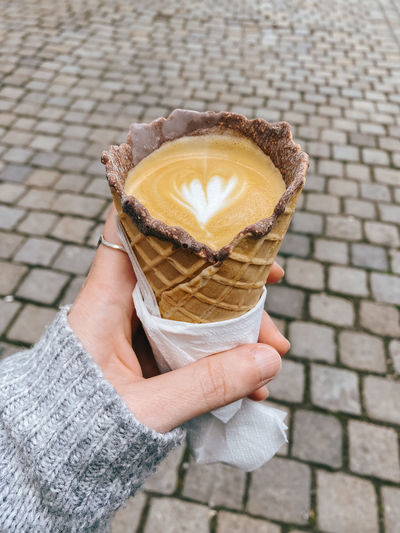 Cropped hand holding ice cream cone