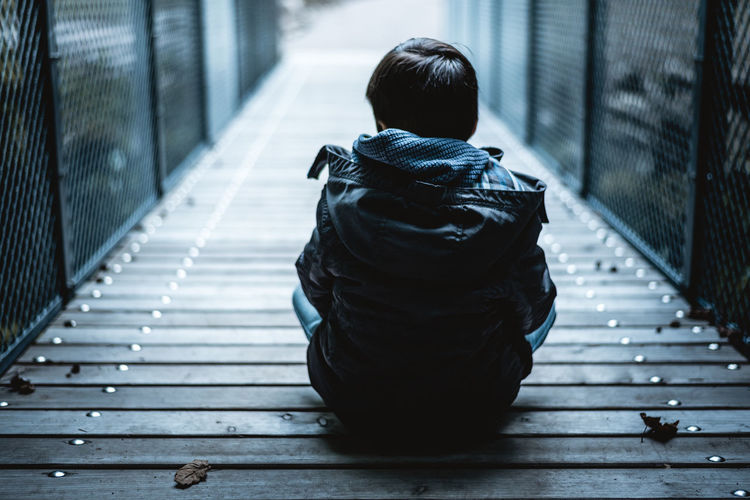 Have a seat and let all the problems fade away for a few minutes. People Outdoors One Person Back Human Back Young Boy Sitting Nature Leisure Activity Lifestyles Casual Clothing Late Summer Autumn Cold Calm Silence Thinking