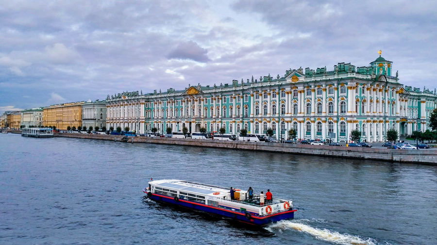 Boat in river with city in background