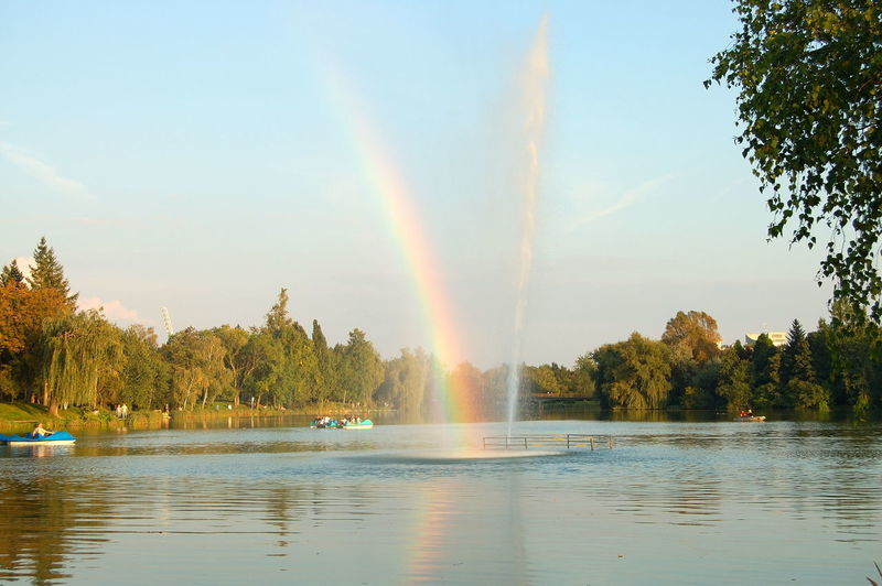 Rainbow over river against sky