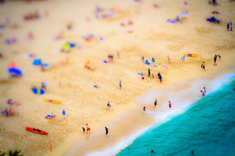 Tilt-shift image of people at beach