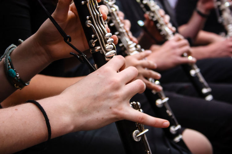 Midsection of musicians playing flute