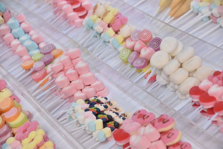 High angle view of various candies and lollipops for sale at market stall