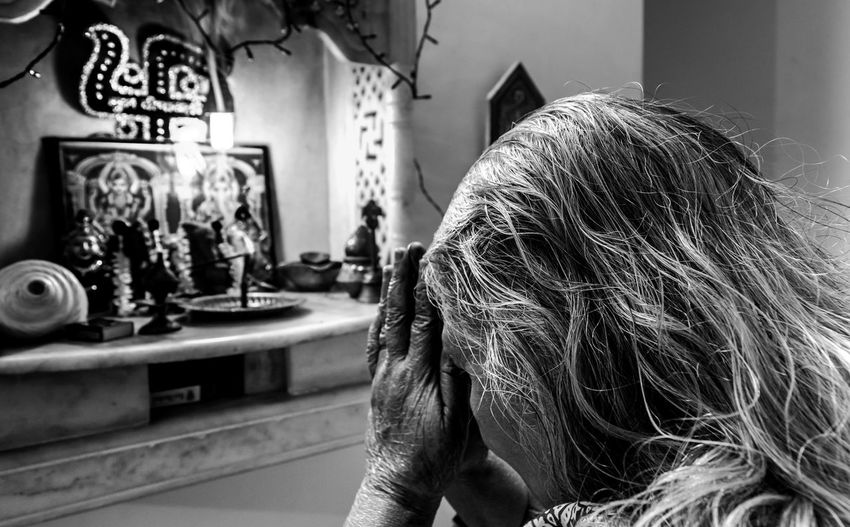 Senior woman praying at temple