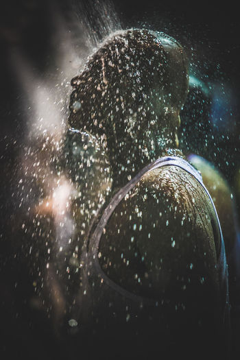 Side view of man taking shower at batu caves
