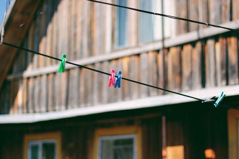 Low angle view of clothespins hanging on clothesline