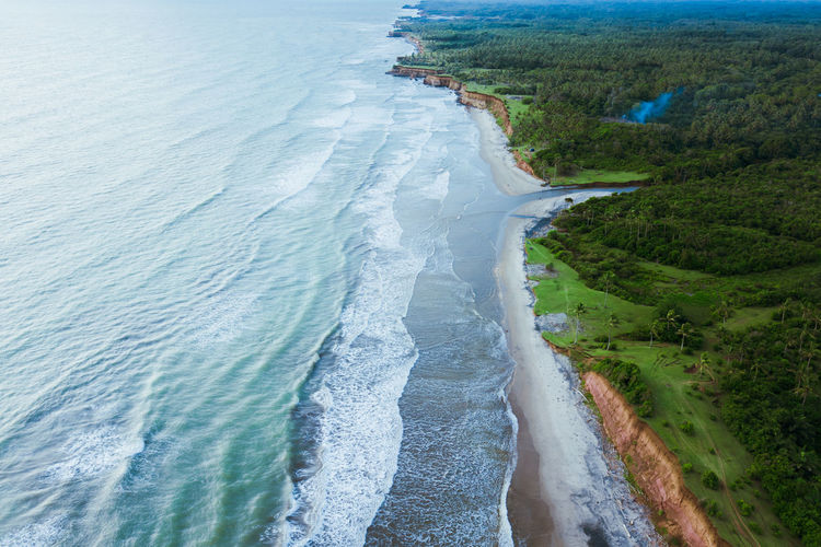 Beach aerial views during the day with beautiful waves in western indonesia