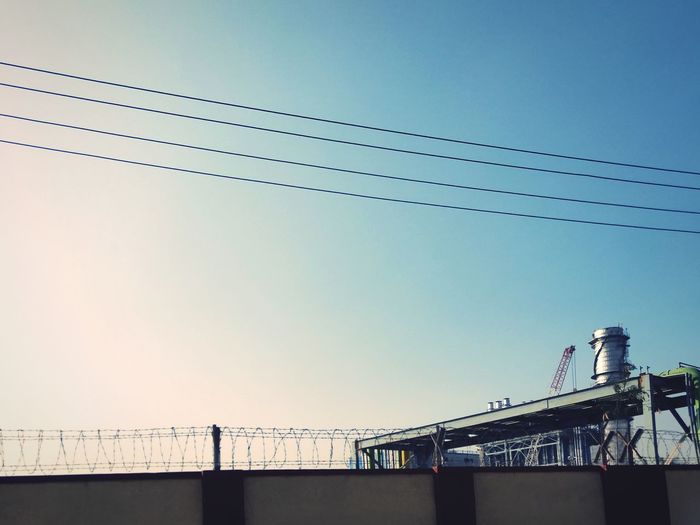 Low angle view of bridge against clear blue sky