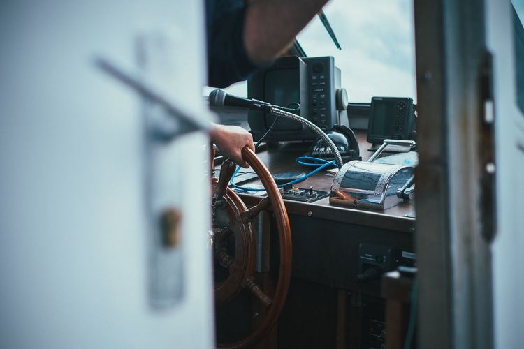 Cropped image of man driving boat