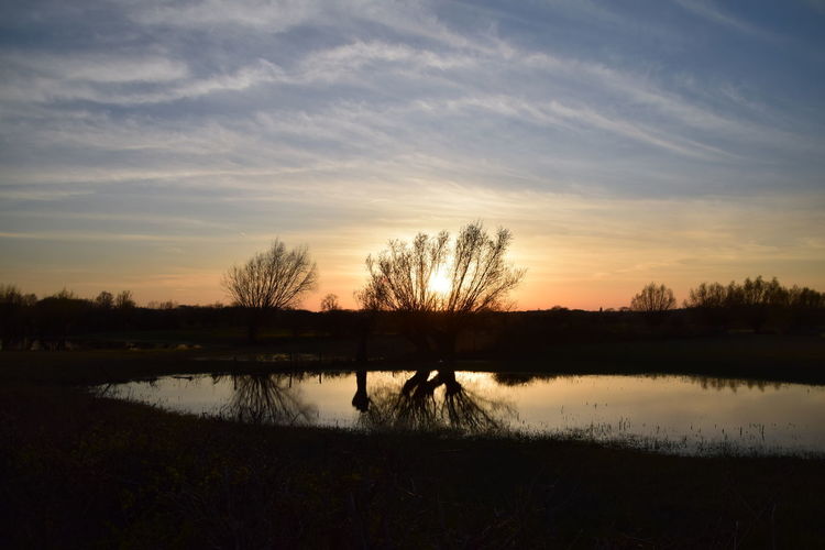 Scenic view of lake against sky during sunset