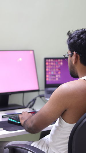 Midsection of man using personal computer