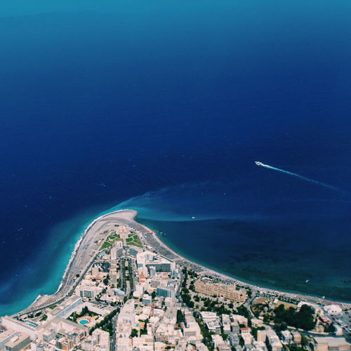 High angle view of sea and buildings in city