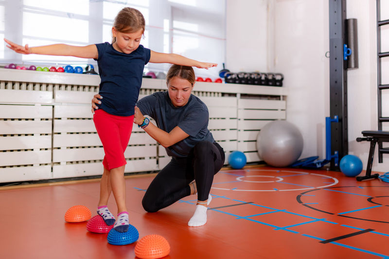 Child training for balance improvement and flat feet correction, walking over spiked half-balls